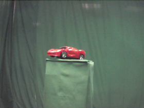 180 Degrees _ Picture 9 _ Red Toy Sportscar.png